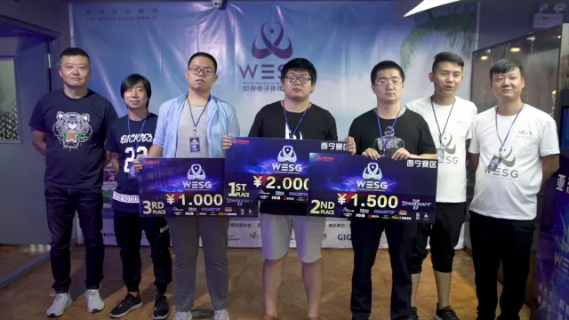 WESG Xining StarCraft II award ceremony; the champion holds the 1st place board